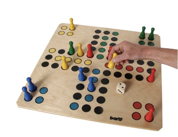 Groot houten Ludo speelbord in gebruik met hand die een pion verplaatst